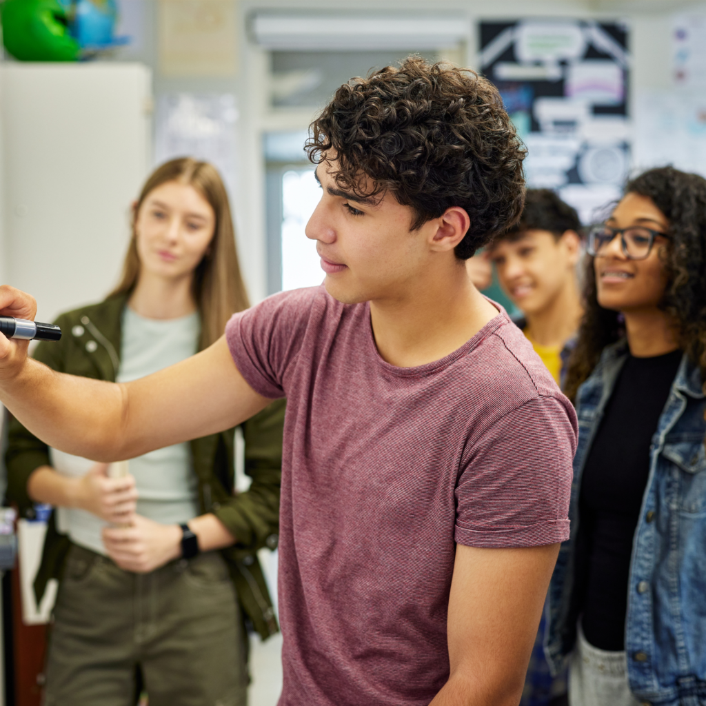 Students working together at a blackboard