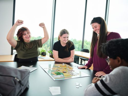 High school students playing a board game